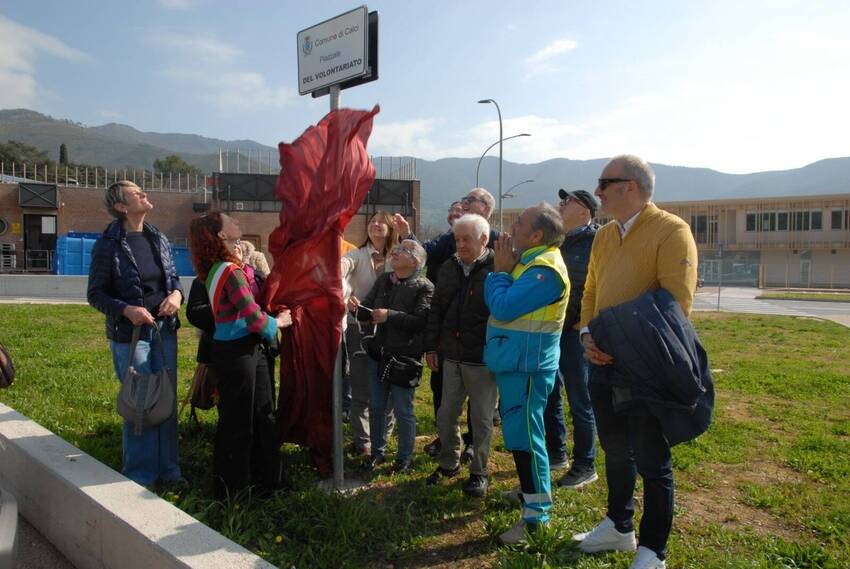 Valentina Ricotta, insieme ad alcuni rappresentanti della giunta, del consiglio comunale e del volontariato locale, scopre la targa "piazzale del volontariato" 